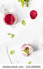 Tasty Cottage Cheese Parfait With Raspberry Sauce And Mint In A Glass Jar. Diet Dessert. Light Grey Stone Concrete Background. Copy Space.