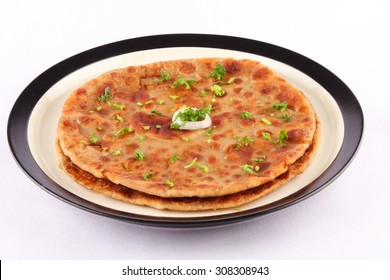 Tasty And Crispy  Aloo Paratha Served In Plate.