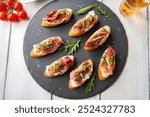 Tasty crostini with cheese cream and prosciutto crudo, italian appetizers 