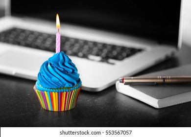 Tasty cupcake on working place - Shutterstock ID 553567057