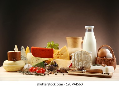 Tasty Dairy Products On Wooden Table, On Dark Background
