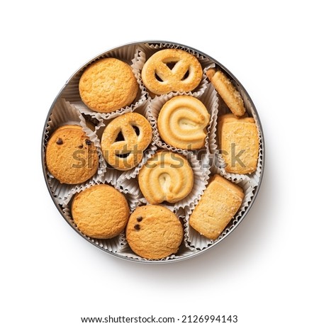 Tasty danish butter cookies in a tin isolated on a white background. Set of crispy shortbread biscuits in an open container cutout. Baked pastry, breakfast, sweet food, calories concepts. Top view.