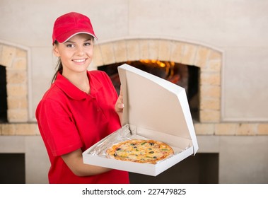 It Is Tasty. Delivery Woman Is Showing The Pizza.