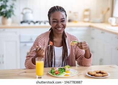 Tasty Dieting. Portrait Of Cheerful Young Black Female Eating Breakfast In Kitchen, Joyful Smiling African American Woman With Dental Braces Enjoying Healthy Delicious Meal At Home, Free Space