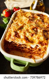 Tasty Dish Of Oven-baked Lasagne Topped With Golden Melted Mozzarella Cheese Viewed Close Up From Above With Fresh Ingredients