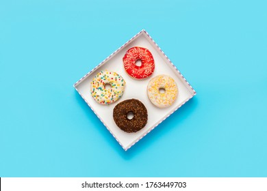 Tasty Donuts In A Box On A Blue Background. Concept Of Sweets, Bakery, Pastries, Coffee Shop. Banner. Flat Lay, Top View