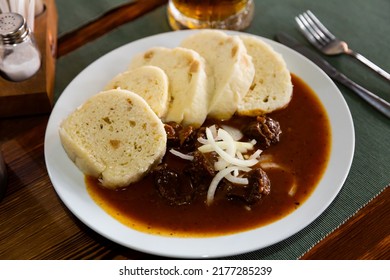 Tasty dumplings (knedliky) served in Prague pub with beef stewed in gravy. Traditional Czech dish