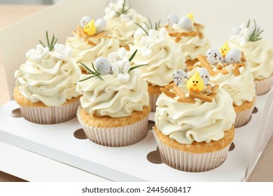 Tasty Easter cupcakes with vanilla cream in box, closeup - Powered by Shutterstock