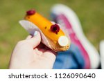 tasty eclairs in the hands