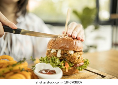 Tasty fired chicken with arugula and mayonnaise sauce served on wooden board, fired chicken Cheese Burger with Spicy Seasoned Curly Fries Ready to Eat - Powered by Shutterstock