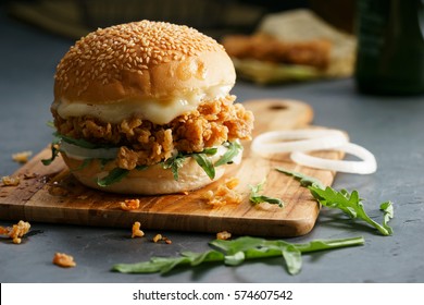 Tasty fired chicken with arugula and mayonnaise sauce served on wooden board - Powered by Shutterstock