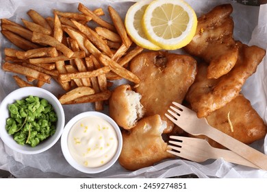 Tasty fish, chips, sauce and peas on tray, top view - Powered by Shutterstock