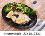 Tasty fish tintorera blue shark (Prionace glauca) with vegetables and lemon