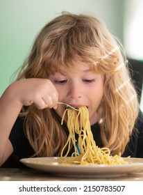 Tasty Food, Messy Child Eating Spaghetti. Young Kid Sitting On The Table Eating Healthy Food With Funny Expression On Face.