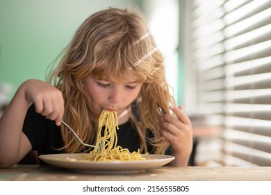 Tasty Food, Messy Child Eating Spaghetti Close Up Portrait Of Funny Kid Eating. Little Boy Having Breakfast In The Kitchen.