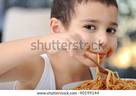 Tasty food, messy child eating spaghetti