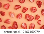 Tasty freeze-dried strawberries on orange background