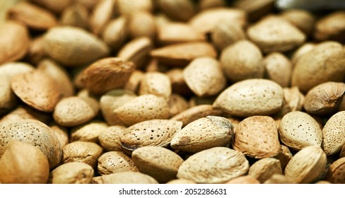 Tasty fresh almond nuts, background, texture. Selective focus. High quality photo
