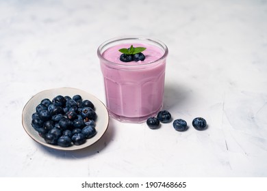 Tasty Fresh Blueberry Yoghurt Shake Dessert In Glass Standing On White Table Background. Homemade Berry Smoothie. Healthy Eating. Diet Food Yogurt