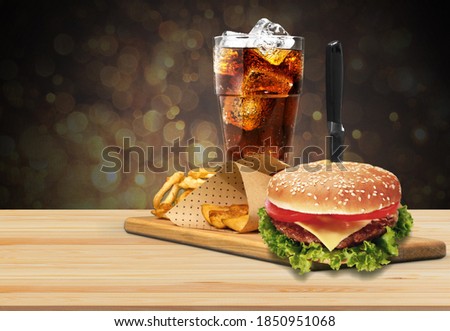 Tasty fresh burger, fries and coke on the wood table