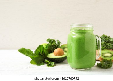 Tasty fresh kale smoothie on white wooden table - Powered by Shutterstock