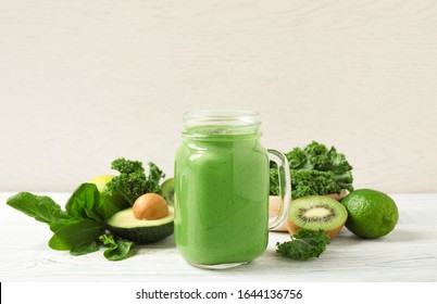 Tasty fresh kale smoothie on white wooden table - Powered by Shutterstock