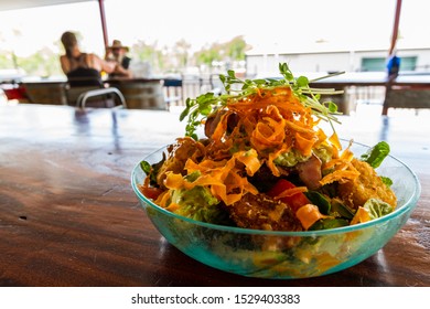 Tasty Fresh Salad On Wooden Table With Unidentified Couple In Background, Northern Territory, Australia