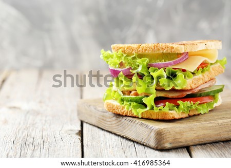 Tasty and fresh sandwiches on a grey wooden table