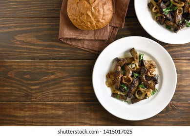 Tasty Fried Beef Liver With Onion On Plate Over Wooden Background With Copy Space. Pieces Cooked Liver (offal) From Beef. Top View, Flat Lay