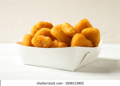 Tasty Fried Chicken Nuggets On White Wooden Table