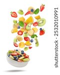 Tasty fruit salad. Fresh ingredients and bowl in air on white background