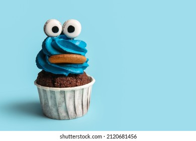 Tasty Funny Cupcake For Halloween Celebration On Blue Background