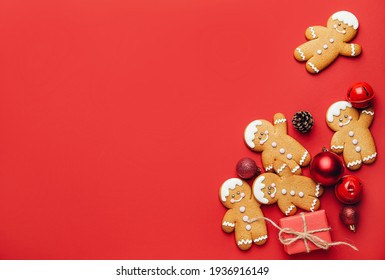 Tasty gingerbread cookies and Christmas decor on color background