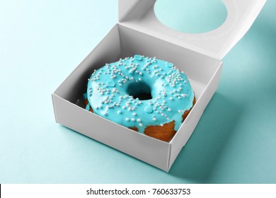 Tasty Glazed Donut In Box On Color Background