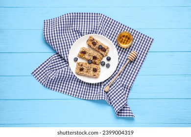 Tasty granola bars served on light blue wooden table, top view - Powered by Shutterstock