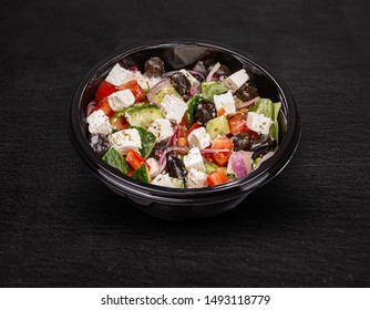 Tasty Greek Salad With Feta, Olives And Tomatoes In A Plastic Bowl