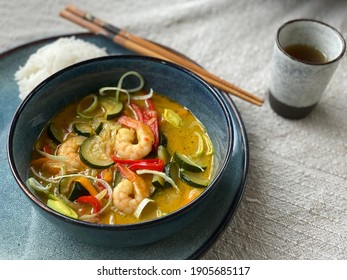 Tasty green curry with shrimps. Delicious Thai dish. Asian kitchen.