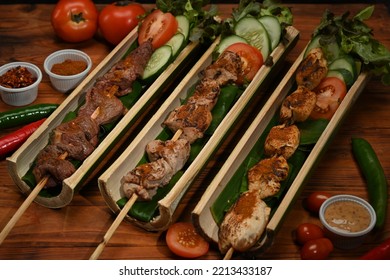 Tasty Grilled Meat With Sichuan Pepper In Bamboo Barrel Plate And Vegetable On Rustic Wooden Table