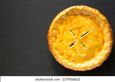 Tasty Homemade Canadian Tourtiere Meat Pie On A Black Surface, Top View. Flat Lay, Overhead, From Above. Space For Text.