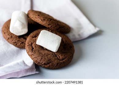 Tasty Homemade Chocolate Chip and Marshmallow Dark Chocolate Cookies on Blue Background Horizontal - Shutterstock ID 2207491381