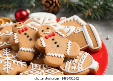 Tasty homemade Christmas cookies on red plate, closeup view