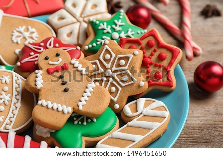 Tasty homemade Christmas cookies on blue plate, closeup view