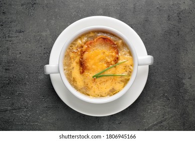 Tasty Homemade French Onion Soup On Grey Table, Top View