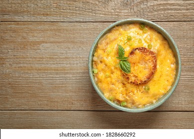 Tasty Homemade French Onion Soup On Wooden Table, Top View. Space For Text