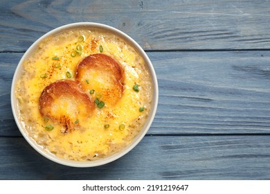 Tasty Homemade French Onion Soup On Blue Wooden Table, Top View. Space For Text