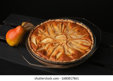 Tasty homemade pear pie on wooden background. 