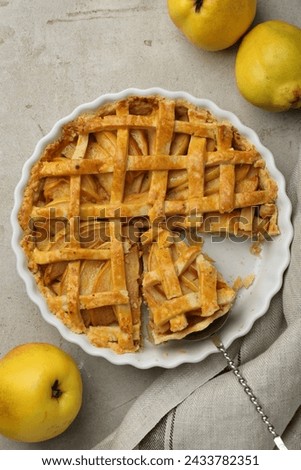 Tasty homemade quince pie with cake server and fresh fruits on light grey table, flat lay