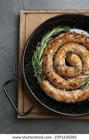 Tasty homemade sausages with spices on grey table, top view