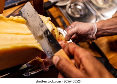 Tasty hot cheese is scooped onto a potato
