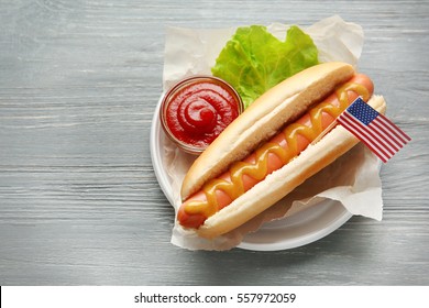 Tasty hot dog with American flag on table - Powered by Shutterstock